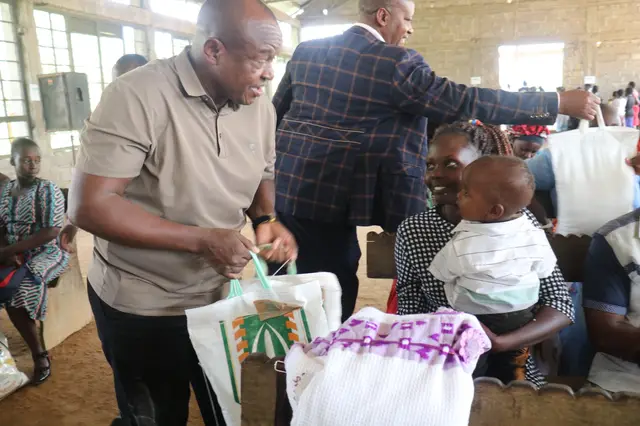 Older persons seated together receiving relief food and blankets at a Thayu Life Foundation distribution.